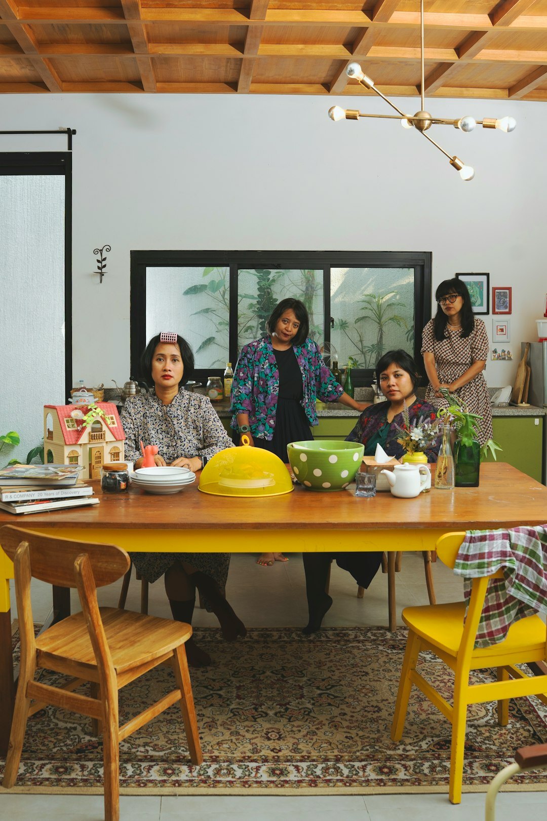 Candid photo of a Danish family laughing together at a kitchen table