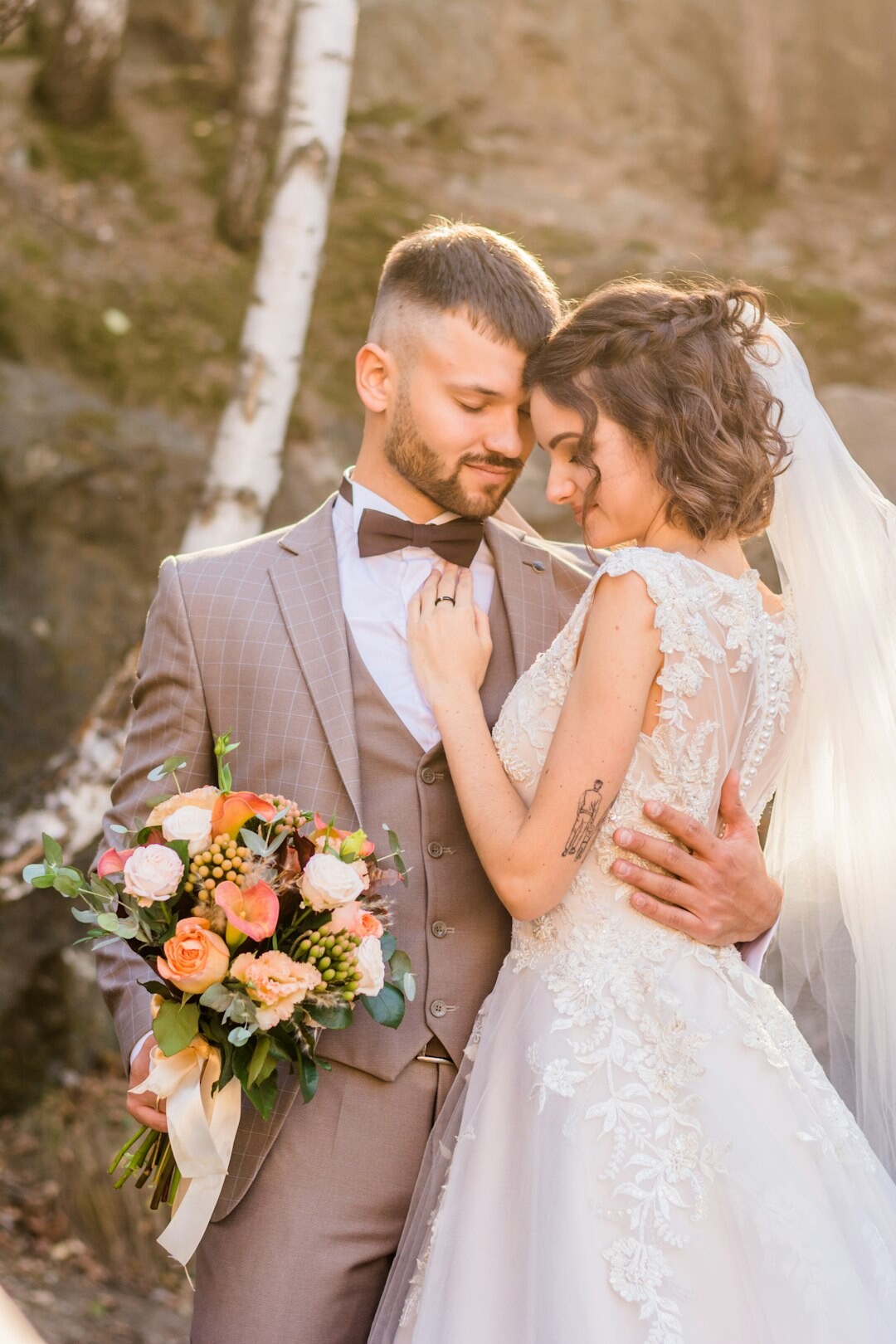 Danish bride and groom embracing in a church courtyard