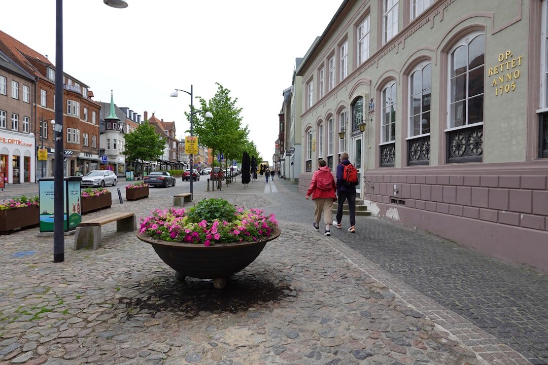 Cyclist crossing a cobbled square in a Danish city