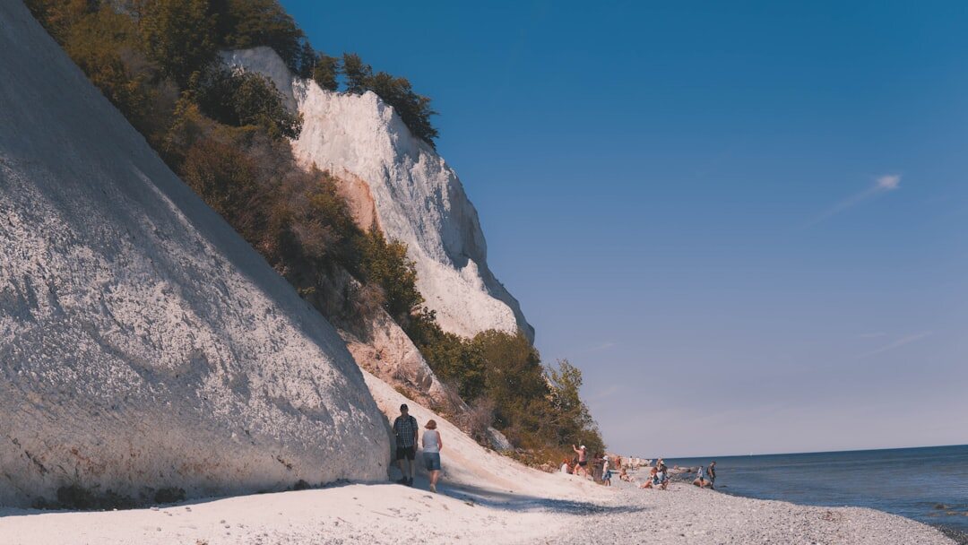 Young couple walking hand in hand on a Danish beach